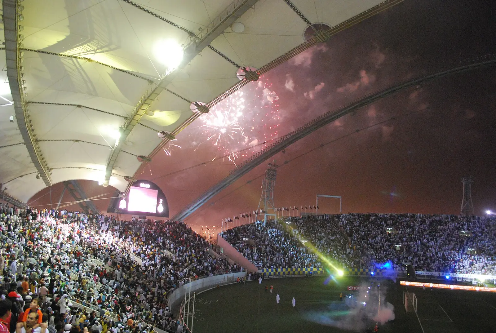 Khalifa International Stadium at night with a full crowd under the roof canopy