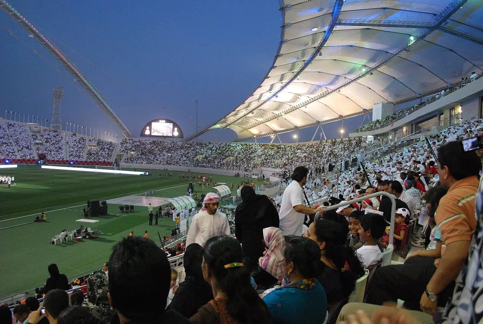 Floodlit crowd beneath the white tensile roof of Khalifa International Stadium